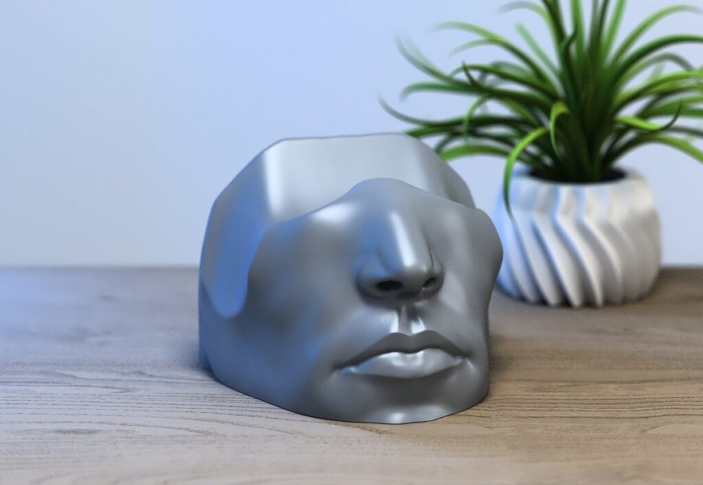 人間の顔をモチーフにした、PS5コントローラー用のユニークな3Dプリントスタンドの画像。