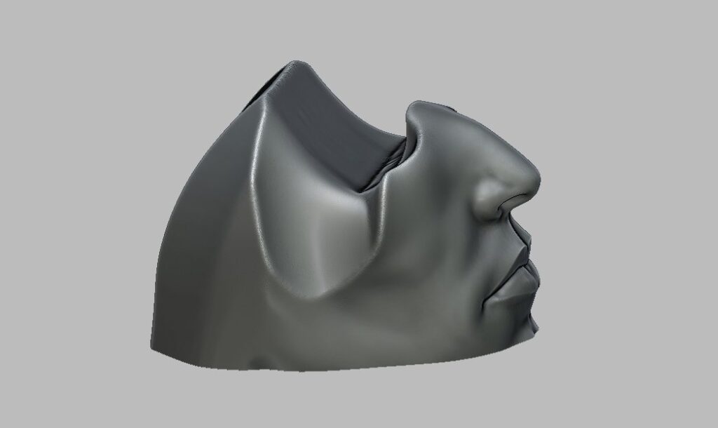 人間の顔をモチーフにした、PS5コントローラー用のユニークな3Dプリントスタンドの画像。