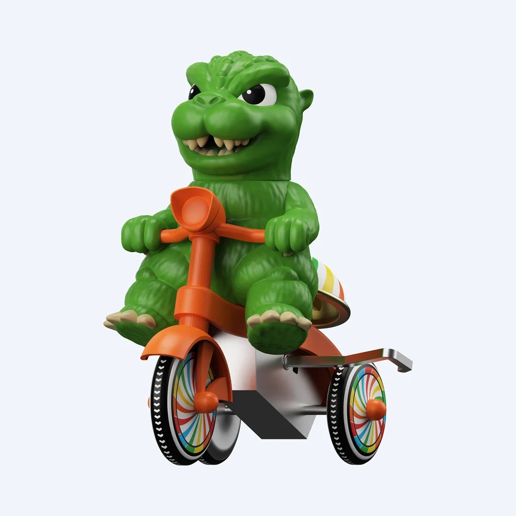 Super7が展開する「Super Cycles」シリーズから登場した、グリーンのゴジラが赤いゼンマイ式三輪車に乗ったフィギュア「Super7 Super Cycles - Godzilla (Green w/ Red Trike)」の画像。